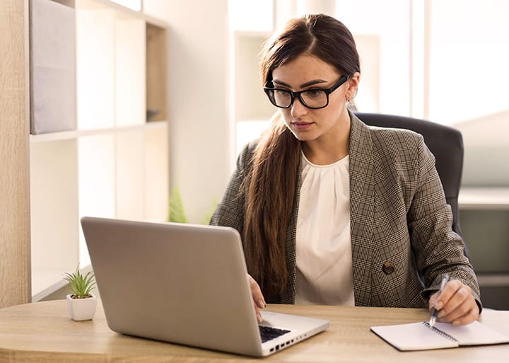 front-view-businesswoman-working-laptop-office - Seahawk Why You Should Hire a WordPress Consultant?