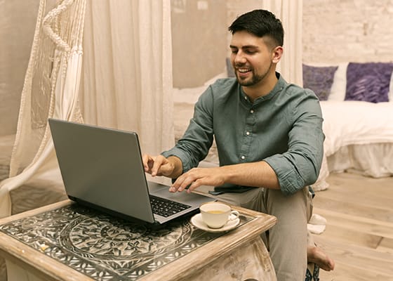 full-shot-smiley-man-working-laptop - Copy - Seahawk
