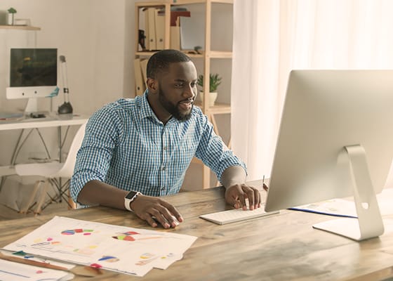 Young african man working in the office business - Seahawk