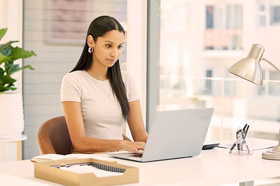 Focused and ready to tackle this day. Shot of a young project manager working on laptop - Seahawk Focused and ready to tackle this day. Shot of a young project manager working on laptop