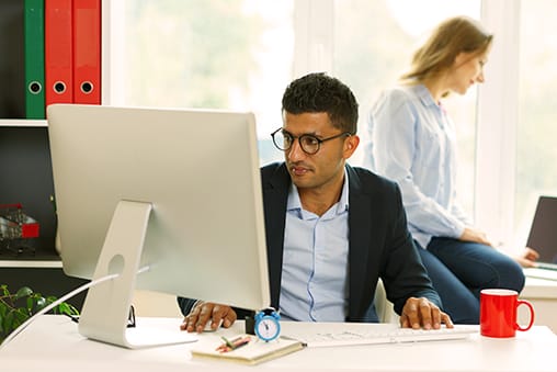 Beautiful young woman and man working from home - Seahawk