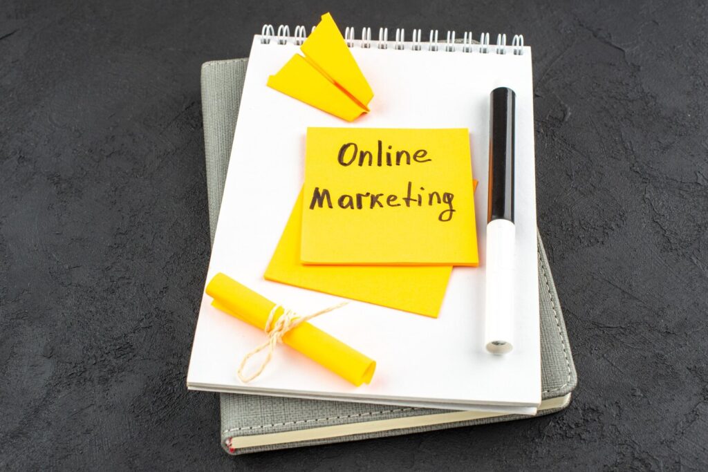 bottom-view-online-marketing-written-yellow-sticky-note-black-marker-notepad-dark-background_140725-112177 - Seahawk Digital Agency Need a Freelancer Alternative?