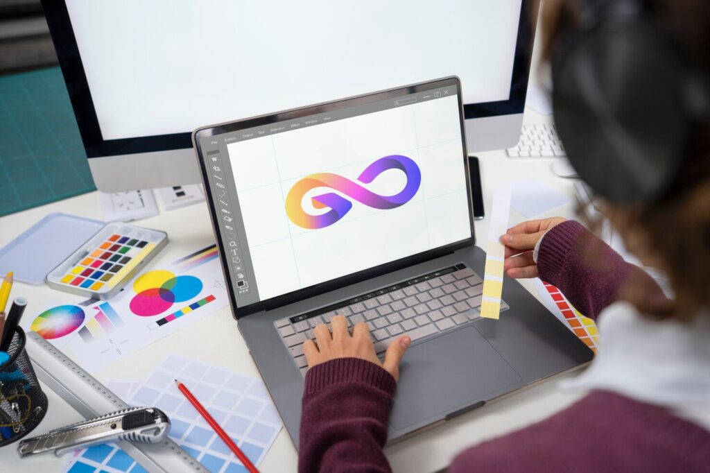 young-female-designer-working-her-laptop_23-2149142106 - Seahawk importance-of-logo-design
