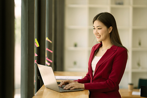 Young woman working on a laptop. - Seahawk Expertise in Cybersecurity-Focused Design and Development